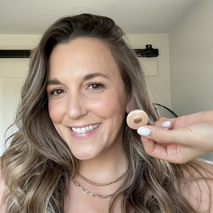 Smiling woman while holding the anxiety patch