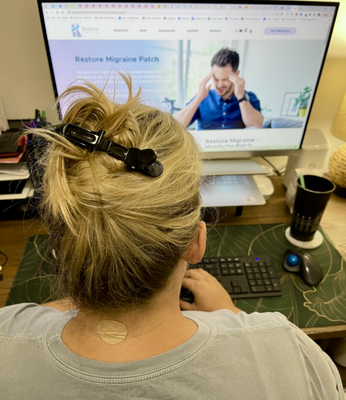An image of a woman working at her desktop computer.