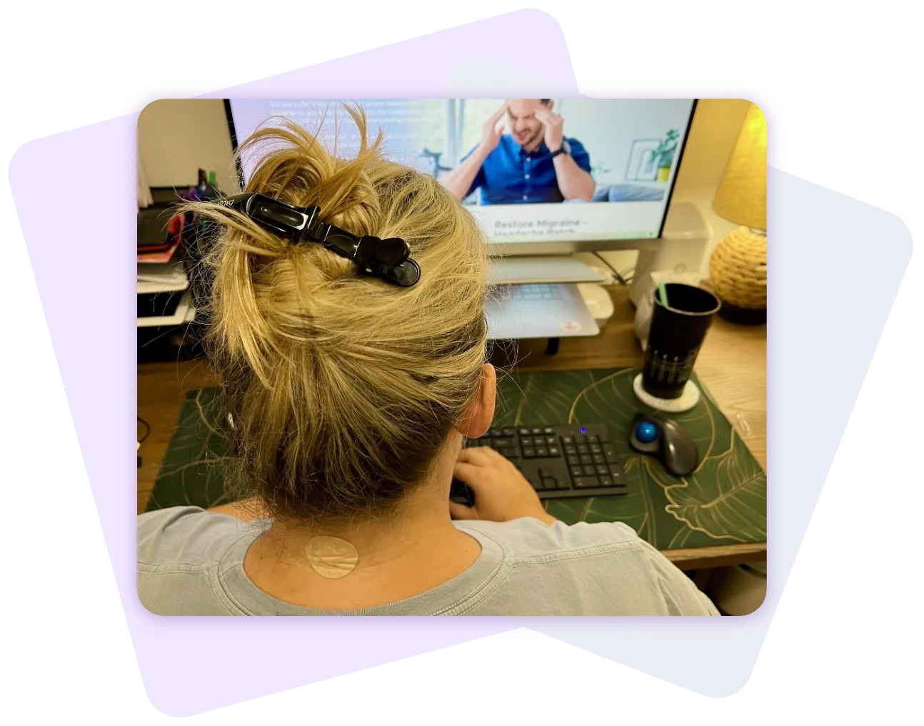 An image of a woman working at her desktop computer.
